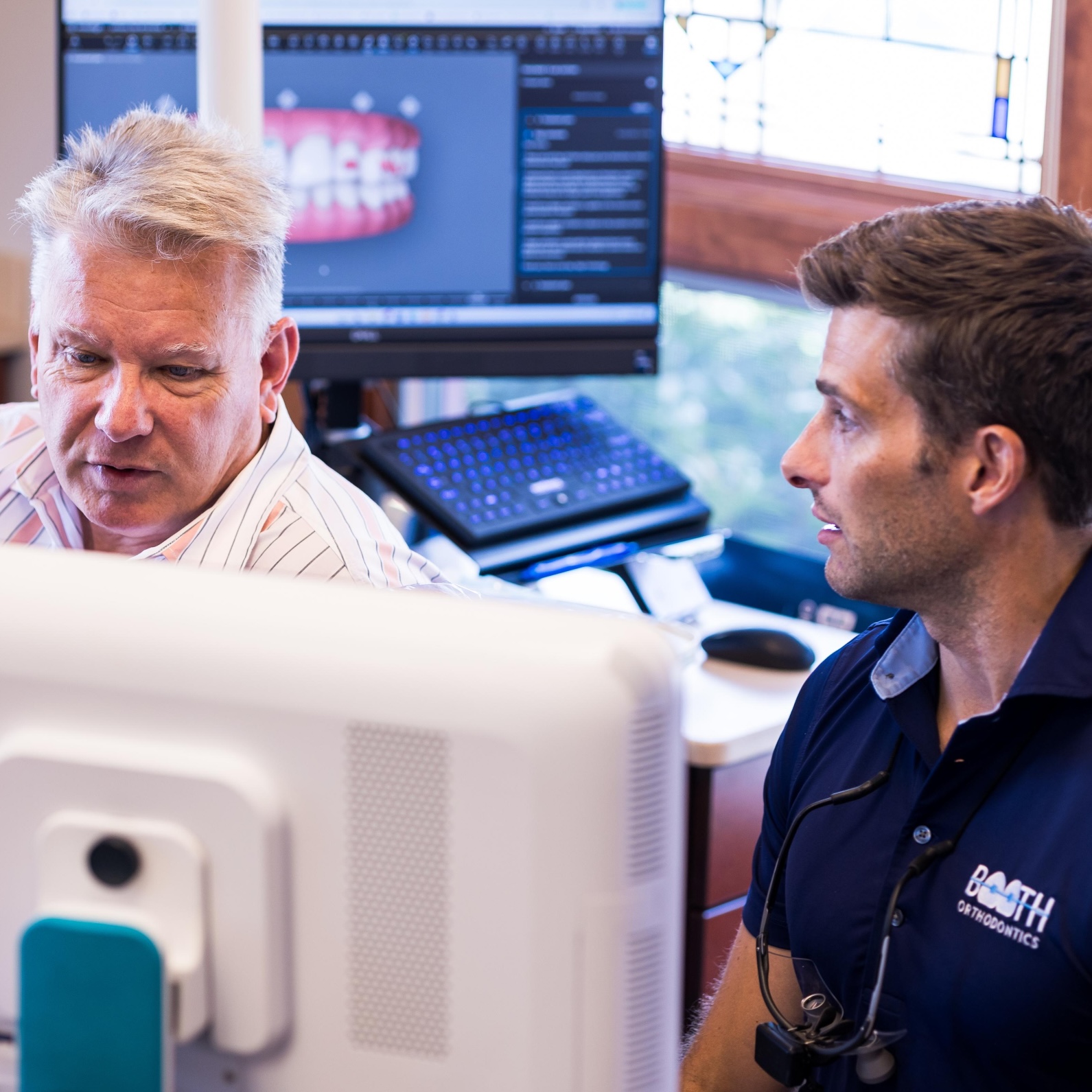 Adult patient and Dr. Booth smiling
